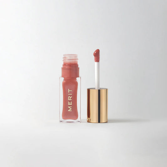 Lip tint with applicator and visible brand name on a white background
