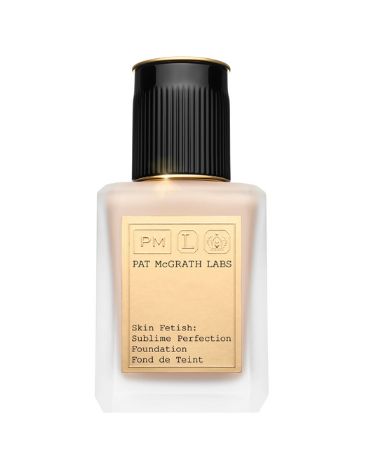 Pat McGrath Labs Skin Fetish Sublime Perfection Foundation in a frosted glass bottle with a black ribbed cap and a gold label, shown on a solid white background.
