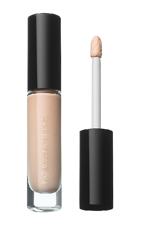 Pat McGrath Labs liquid makeup in a clear tube with a black cap, shown next to its applicator wand on a white background.