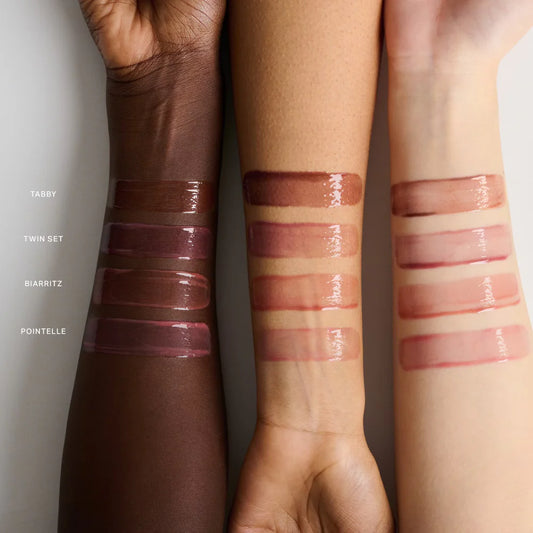 Lipstick swatches on three different skin tones with brand names.